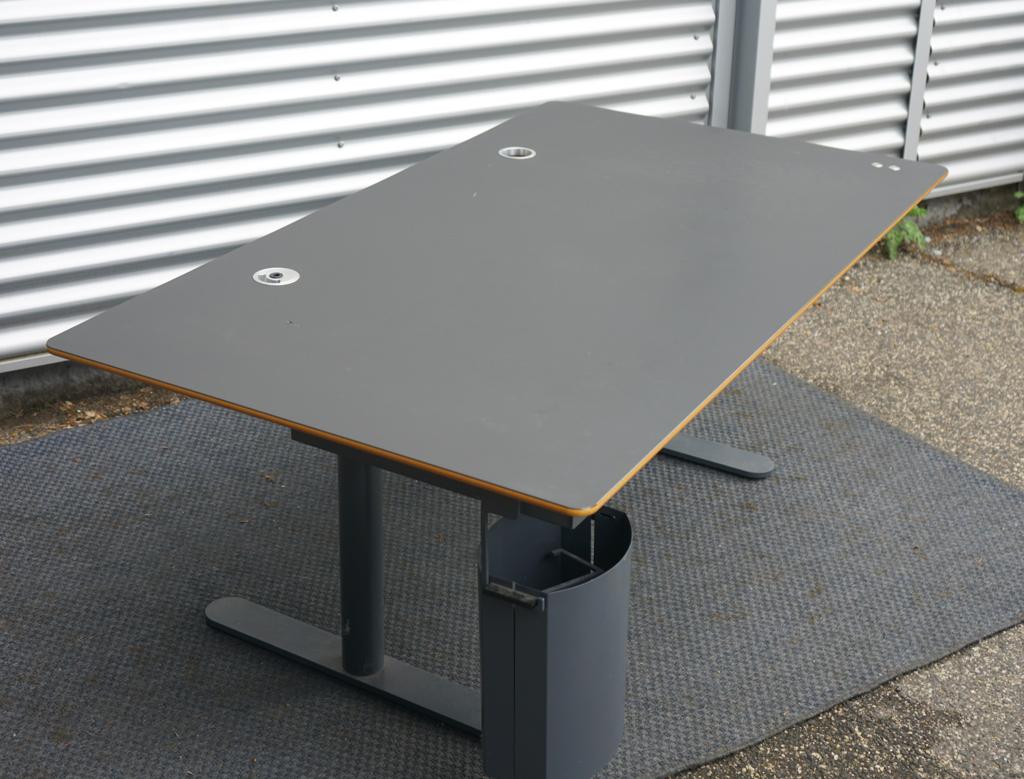 Montana HiLow hæve-sænkebord 160x90 cm i sort linoleum med affasede kanter, set fra skrå vinkel.